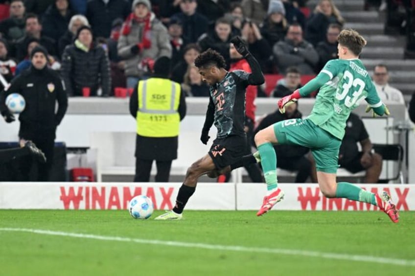 Kingsley Coman (L) catches Stuttgart goalkeeper Alexander Nuebel and wrap's up Bayern's vi