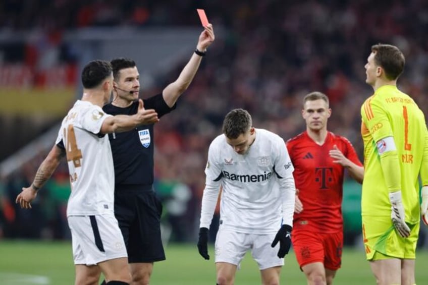 German referee Harm Osmers shows a red card to Bayern Munich's goalkeeper Manuel Neuer, th