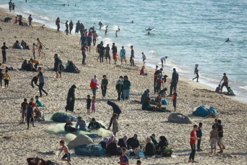 Children paddled in the sea and their friends played ball games on the sand -- but Gaza's