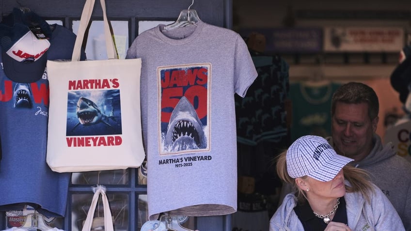 A shopper walks past items featuring the "Jaws" movie at Neptune's Sea Chest gift shop on May 12, 2025, in Vineyard Haven, Massachusetts, on Martha's Vineyard Island. 