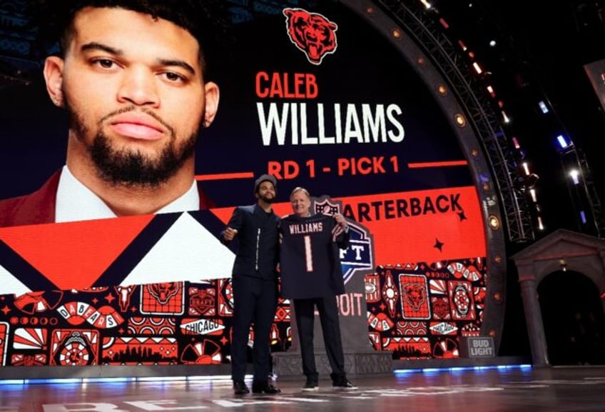 Quarterback Caleb Williams poses with NFL Commissioner Roger Goodell after being selected