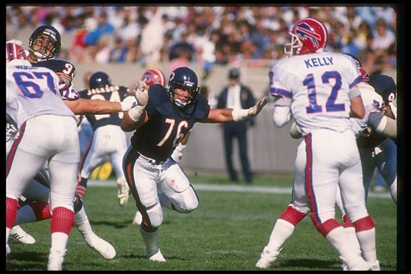 Defensive tackle Steve McMichael of the Chicago Bears goes after Bullalo Bills quarterback Jim Kelly during a game at Rich Stadium in Orchard Park,...