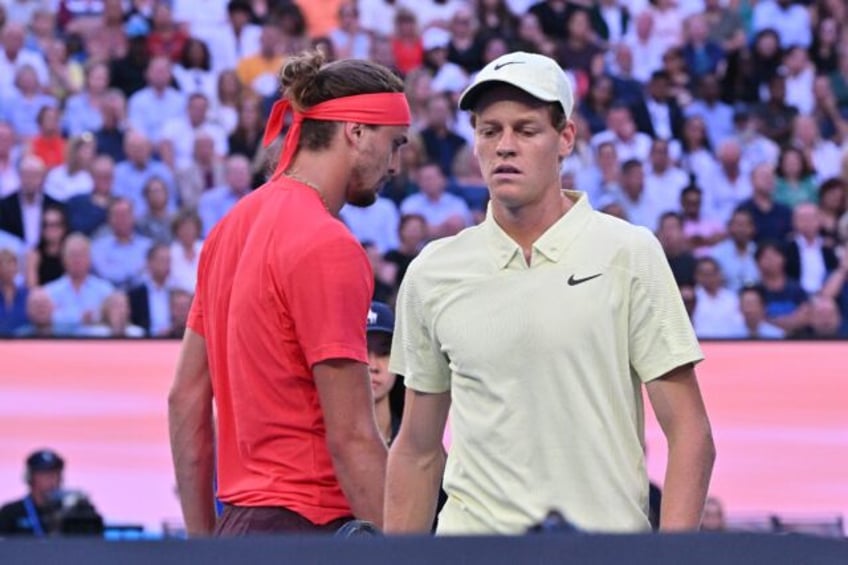 Italy's Jannik Sinner and Germany's Alexander Zverev walk between games during their men's