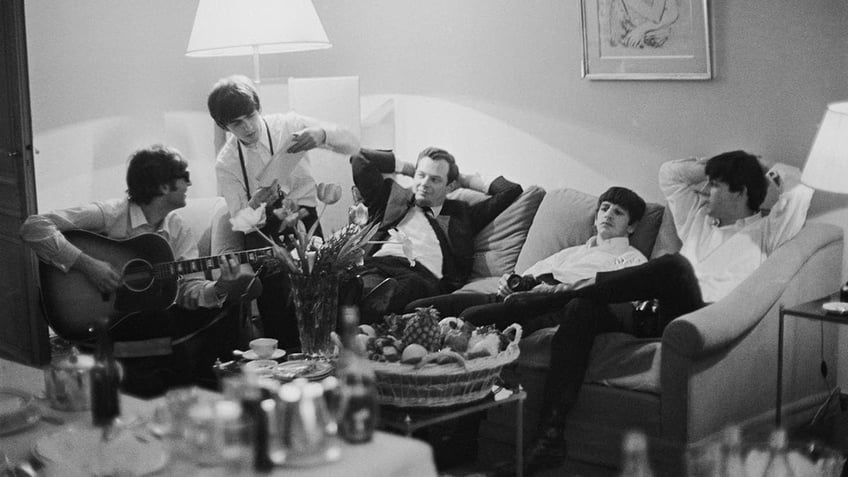 The Beatles hanging out in their hotel room