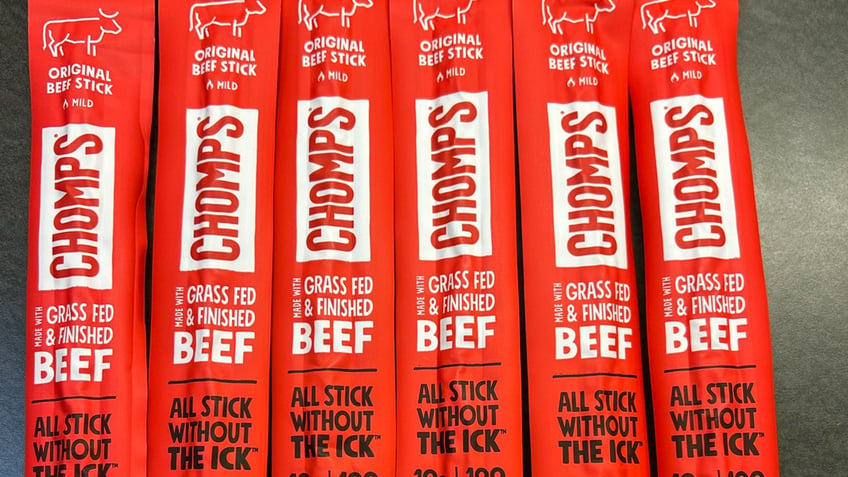 Five Chomps beef sticks in red packaging are shown.