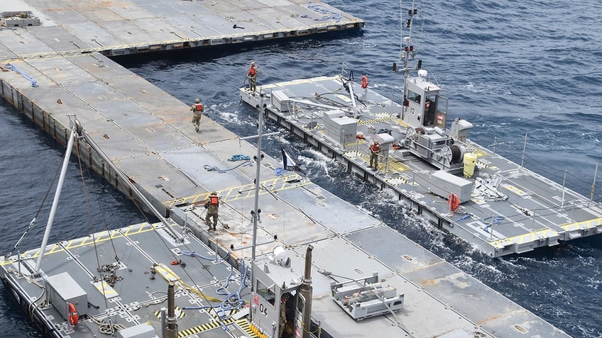 Workers on a metal floating pier