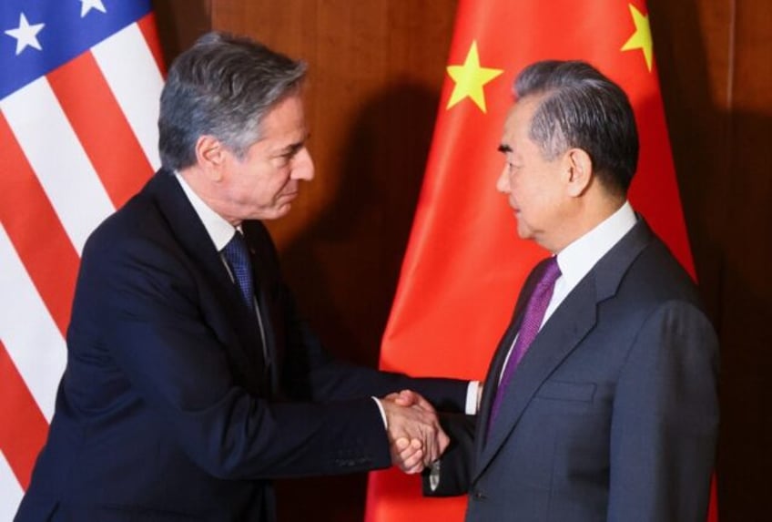 Chinese Foreign Minister Wang Yi shakes hands with US Secretary of State Antony Blinken at