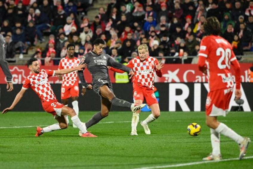 Real Madrid's English midfielder Jude Bellingham (C) scores the opening goal against Giron