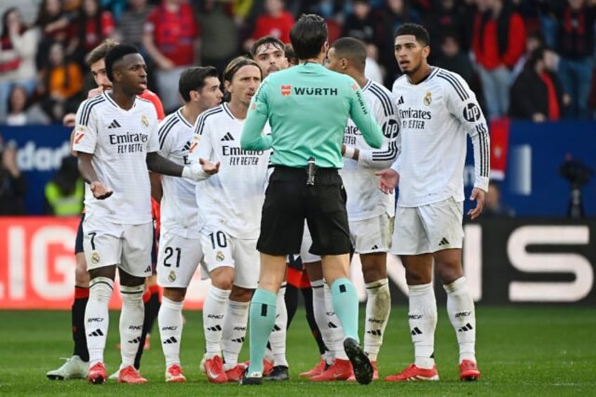 Real Madrid players remonstrate with referee Jose Munuera Montero about Jude Bellingham's