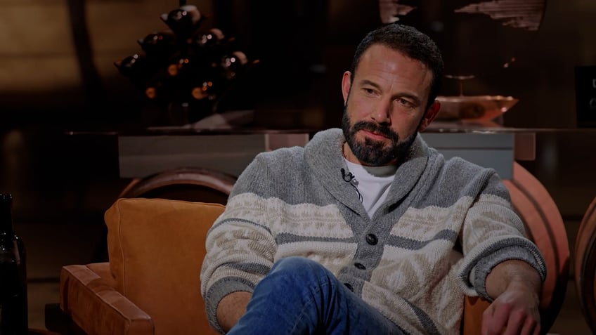 Ben Affleck bundles up in heavy sweater and jeans.