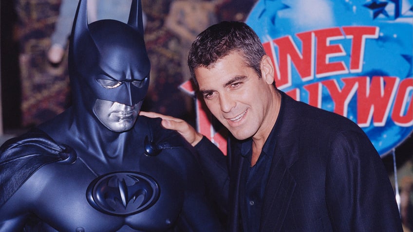 George Glooney next to Batman costume 