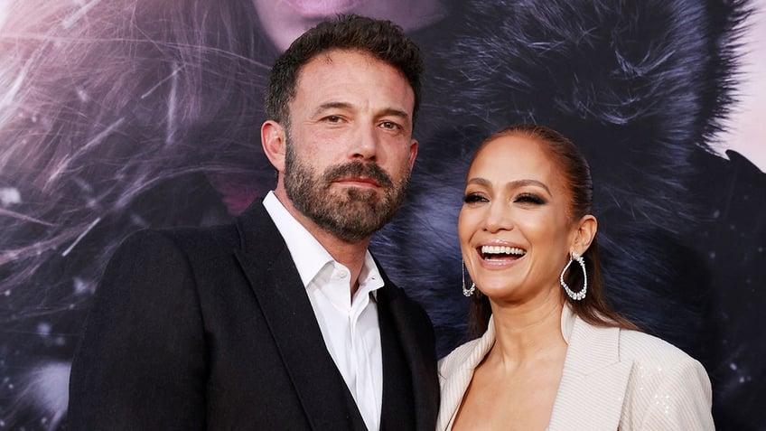 Ben Affleck and Jennifer Lopez pose at an event