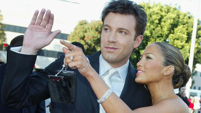 Ben Affleck and Jennifer Lopez smiling looking away from the camera