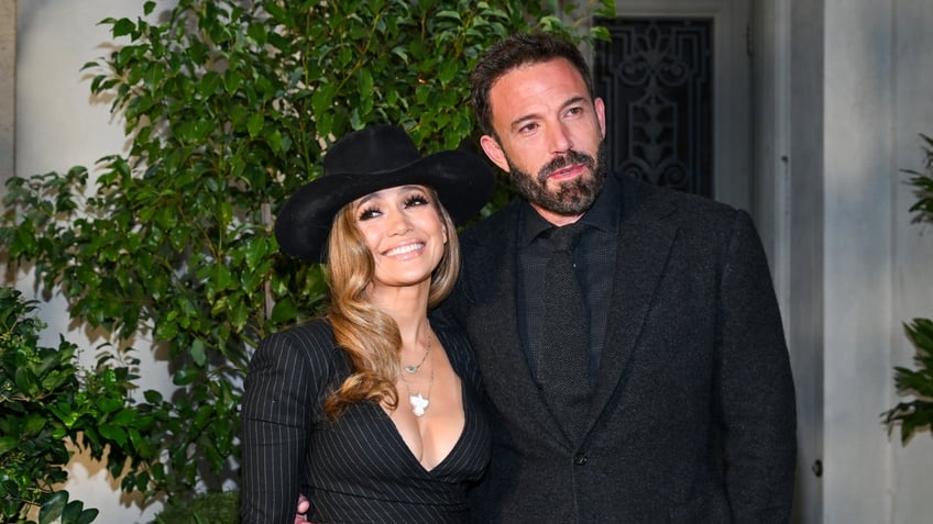 Jennifer Lopez and Ben Affleck pose in an all-black outfits for the Ralph Lauren Spring 2023 runway show