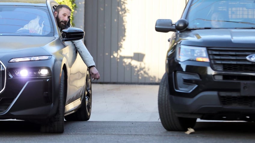 Ben Affleck talking to police officers parked in front of his Brentwood home