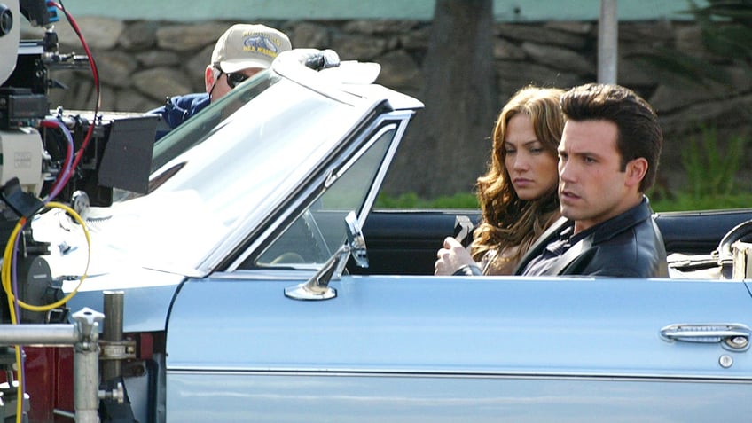 Jennifer Lopez and Matt Damon in a blue convertible film a scene for their movie, "Gigli"