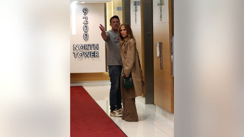 Ben Affleck and Jennifer Lopez in front of an elevator