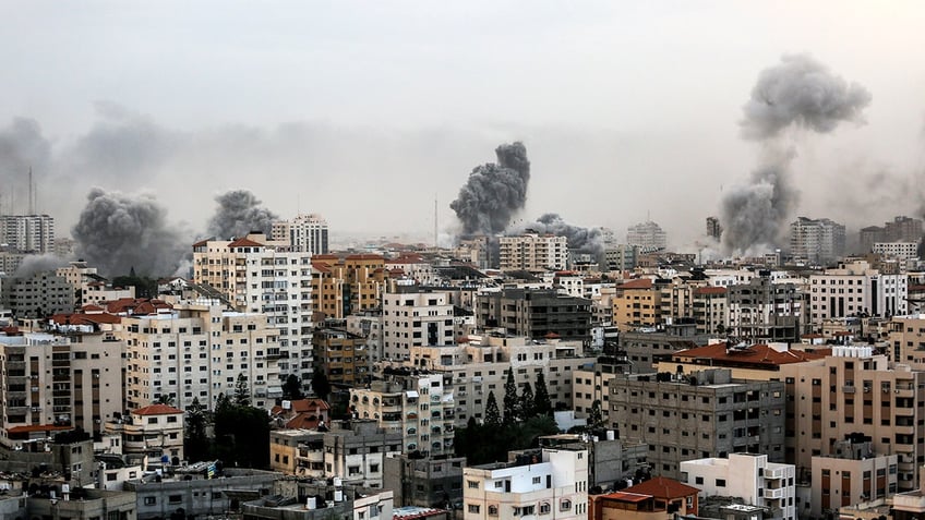 A smoke rises over a building in Gaza City on October 9, 2023 during an Israeli air strike.