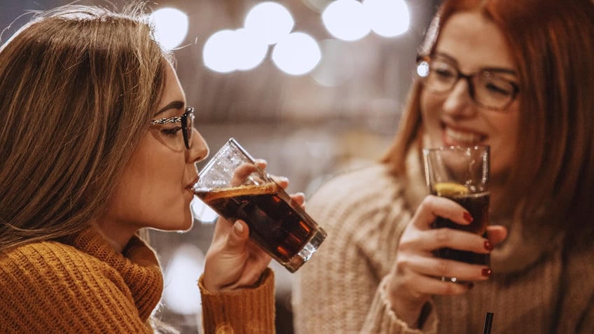 women drinking diet coke