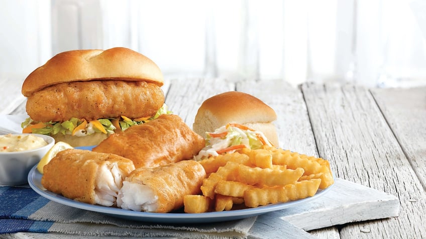 A Culver's seafood and cod sandwich dinner platter is displayed on a table.