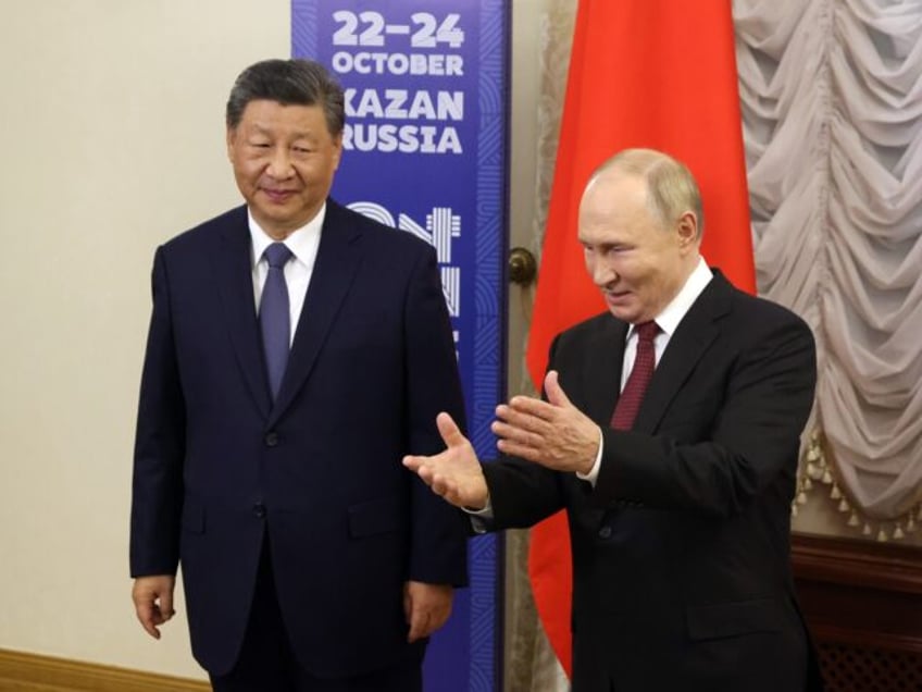 KAZAN, RUSSIA - OCTOBER 22 (RUSSIA OUT) Russian President Vladimir Putin (R) greeets Chine