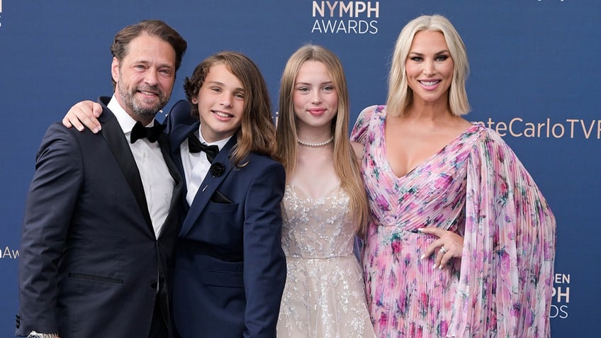 Jason Priestly, Naomi and their children attend a red carpet