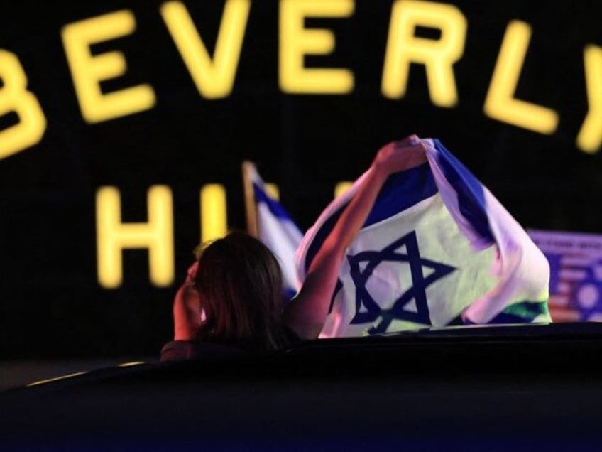 Supporters of Israel demonstrate with national flags in Beverly Hills, California on October 9, 2023, after the Palestinian militant group Hamas launched an attack on Israel. The death toll in Israel has surged to more than 800 after a surprise attack by Hamas, while about 150 "prisoners" were being held …