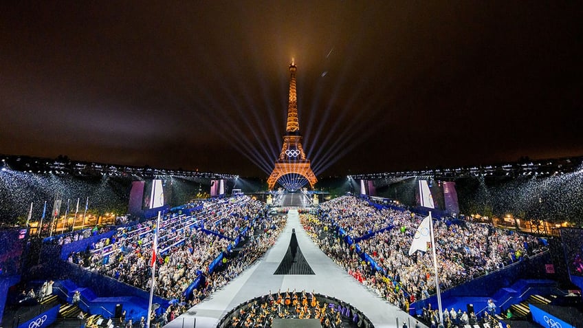 Overview of the Trocadero venue, with the Eiffel Tower looming in the background while the Olympic flag is being raised, during the opening ceremony of the Paris 2024 Olympic Games.