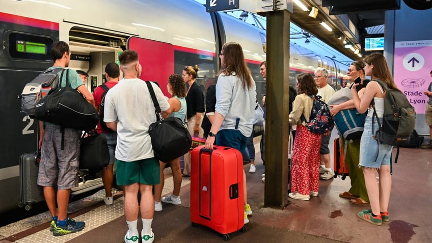 travelers with luggage on french train