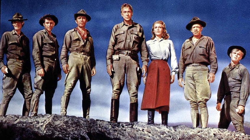 The cast of They Came to Cordura standing together on a mountaintop.