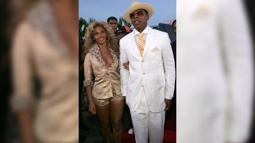 Beyonce sports shorts and matching gold blazer with Jay-Z at VMAs in 2004