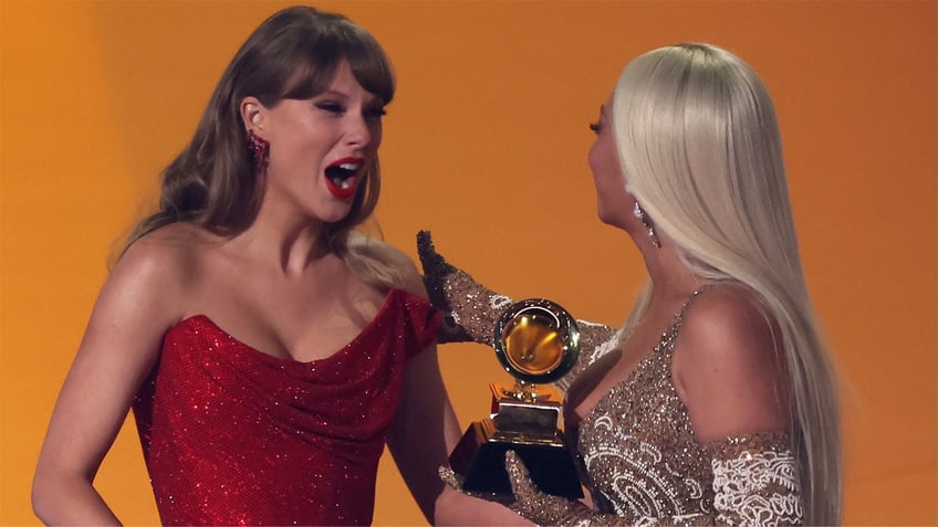 Beyoncé hugs Taylor Swift after Grammy award win.