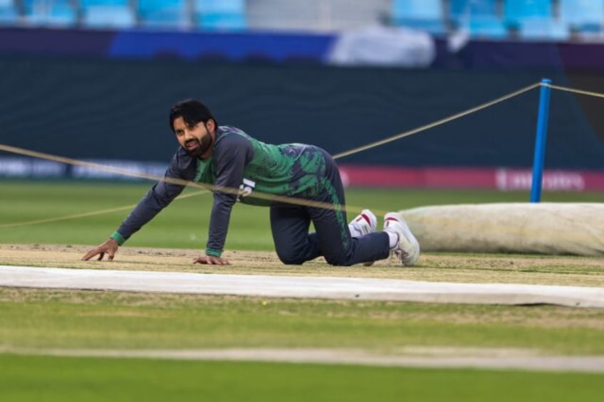 Ground control: Pakistan captain Mohammad Rizwan checks the pitch at the Dubai Internation