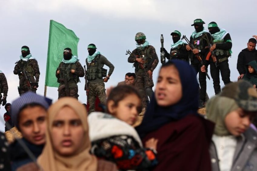 Hamas militants and Gaza residents gathered for the handover of hostages' bodies in Khan Y