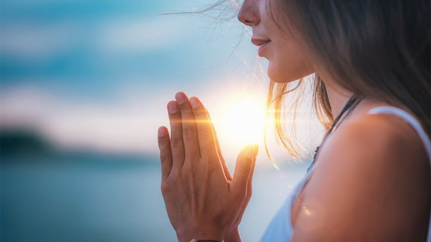 woman with praying hands