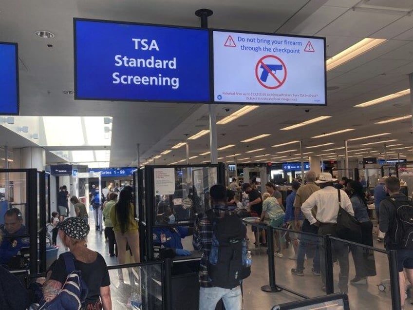 TSA Standard Screening A sign warns travelers not to bring guns through the Transportation