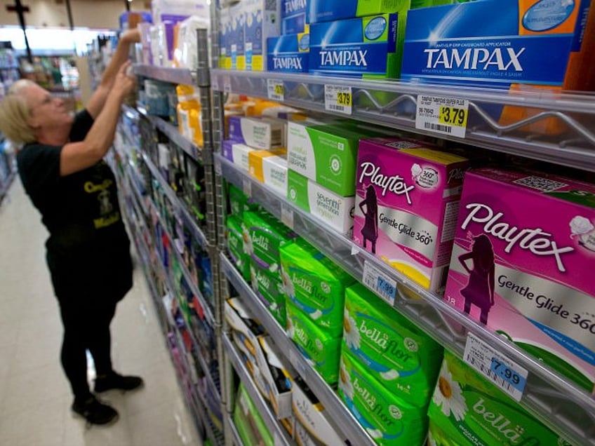 FILE - In this June 22, 2016 file photo, Tammy Compton restocks tampons at Compton's Marke