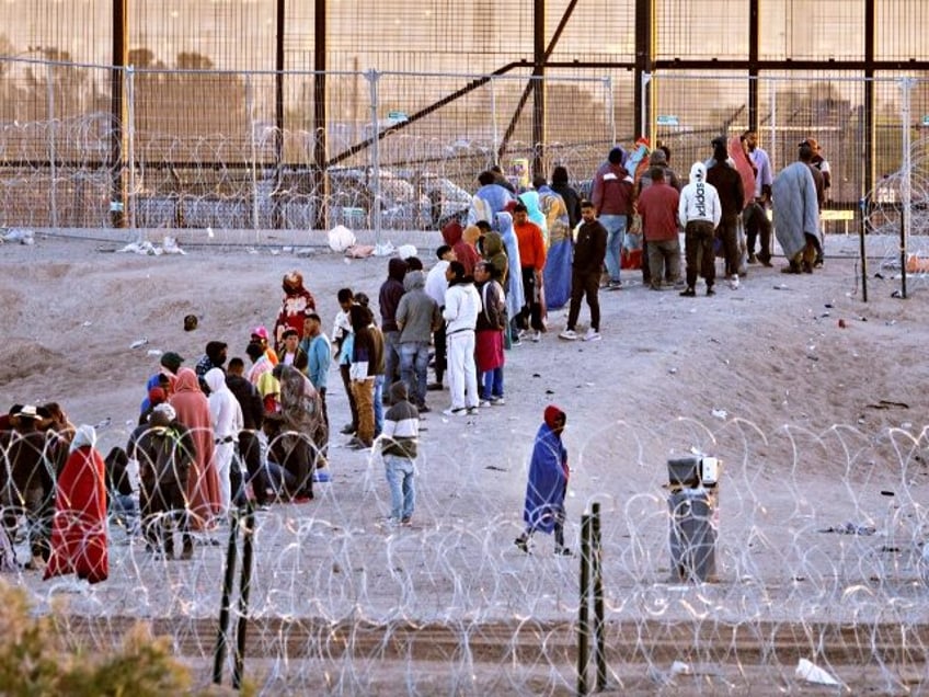 EL PASO, TEXAS - MAY 12: Immigrants wait to be transported and processed by U.S. Border Patrol officers at the U.S.-Mexico border on May 12, 2023 in El Paso, Texas. The U.S. Covid-era Title 42 immigration policy ended the night before, and migrants entering the system now are anxious over …