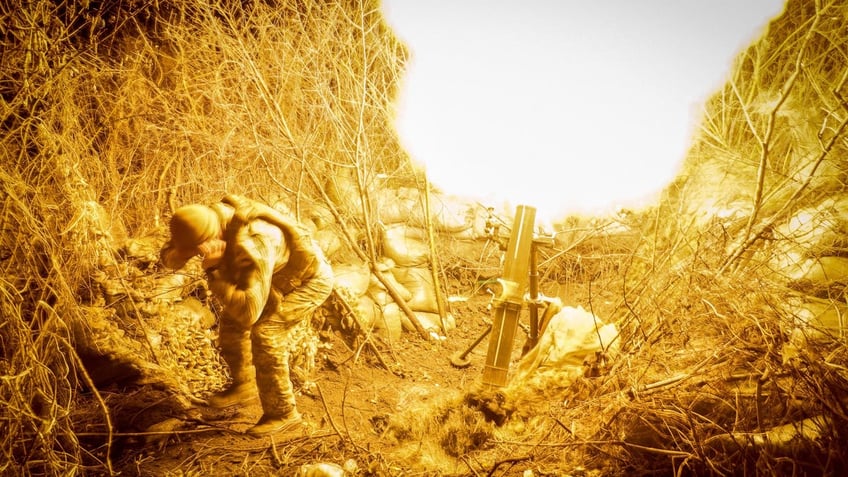 A serviceman of the 24th mechanized brigade named after King Danylo of the Ukrainian Armed Forces fires a 120-mm mortar towards Russian troops at a frontline, November 19, 2024.