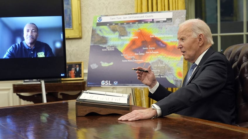 Biden at desk talking to man on monitor, left