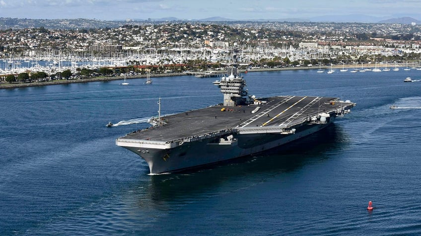 The Navy aircraft carrier USS Theodore Roosevelt is pictured departing from port.