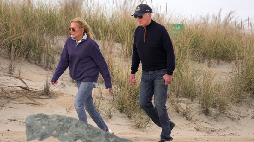 Biden and his wife walking on the beach