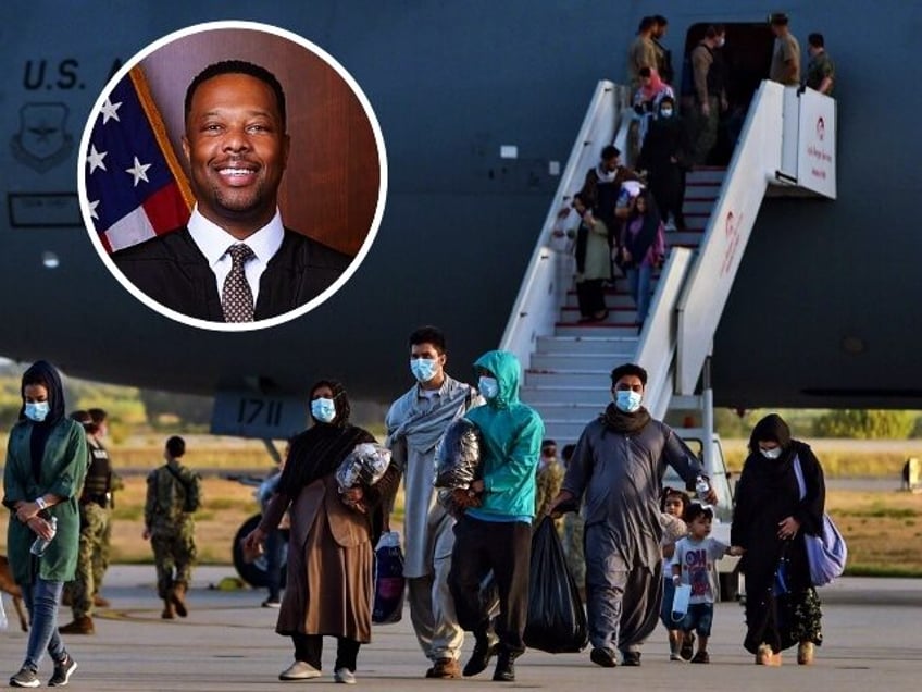 Refugees disembark from a US air force aircraft after an evacuation flight from Kabul at t
