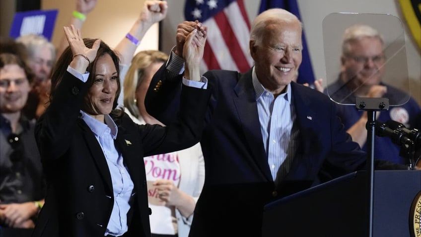 VP Kamala Harris, left, with President Biden, arms raised