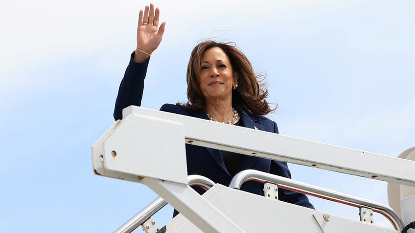 Kamala Harris waving from Air Force Two steps