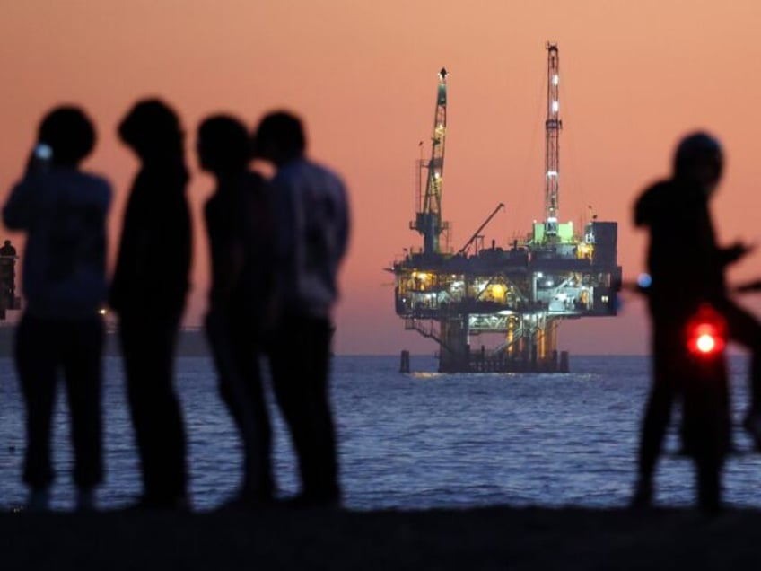 SEAL BEACH, CALIFORNIA - JANUARY 05: People gather at the beach after sunset with offshore