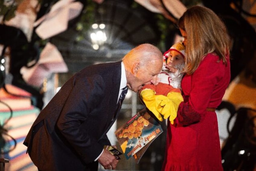 Joe Biden jokingly bit a baby dressed as a chicken as he hosted a Halloween trick-or-treat