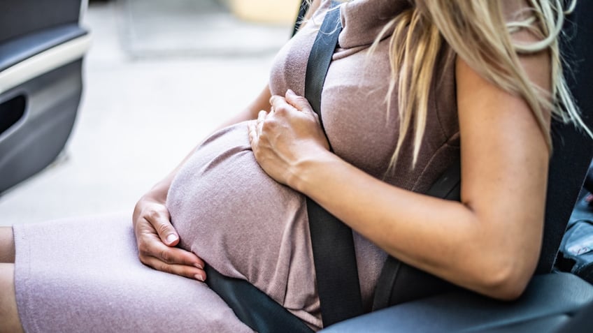 Pregnant woman in car