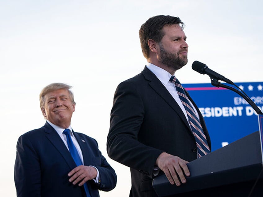 (L-R) Former President Donald Trump listens as J.D. Vance, a Republican candidate for U.S.