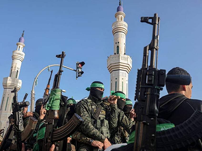 Members of the Ezzedine al-Qassam Brigades, the armed wing of the Palestinian Hamas movement, attend the funeral of their comrade Mohammed Abed during his funeral in Rafah in the southern Gaza Strip on February 16, 2022. - Mohammed Abed, 24, died after one of the tunnels used by the armed wing collapsed in Gaza City. (Photo by SAID KHATIB / AFP) (Photo by SAID KHATIB/AFP via Getty Images)